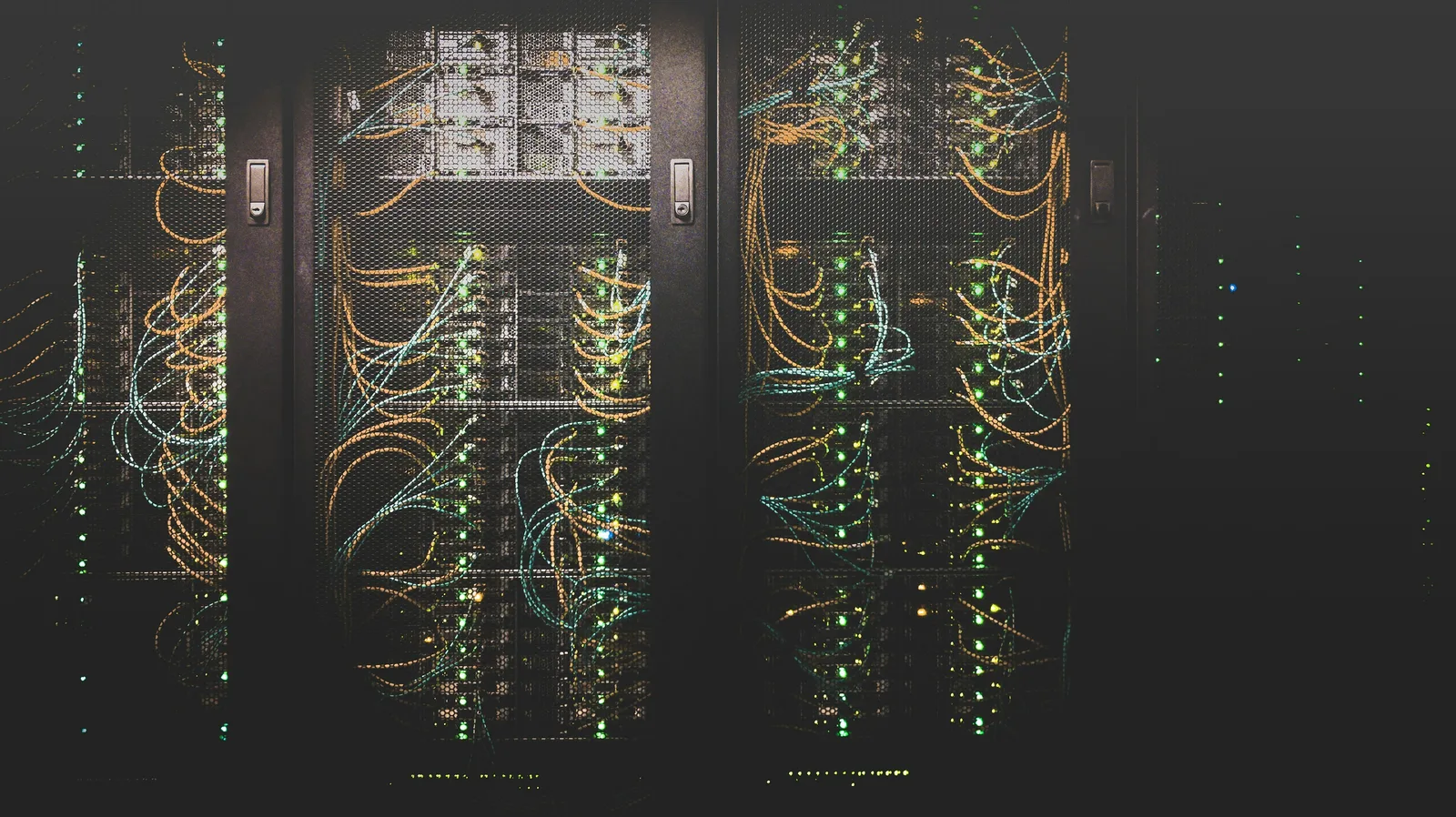 A data-centre aisle with racks of structured network cabling.