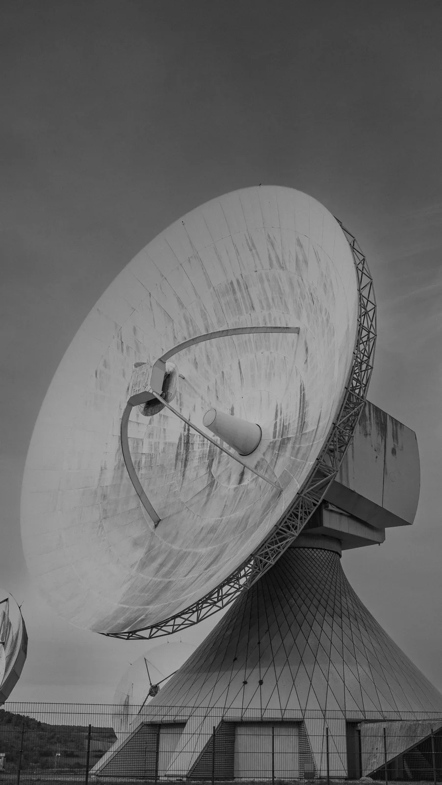 A large parabolic satellite dish mounted on a building.