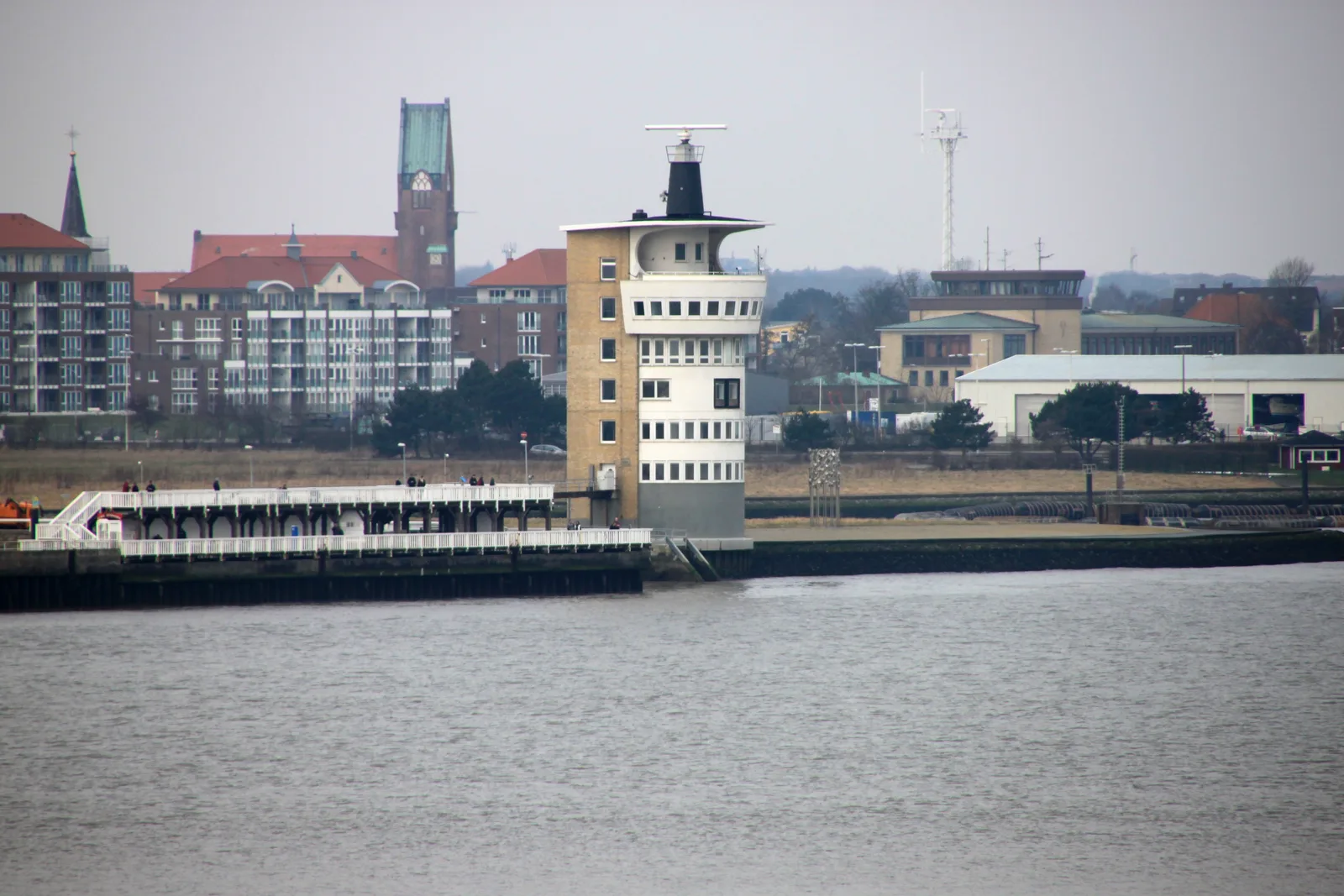 A coastal radar tower rising behind the Alte Liebe pier at the mouth of the Elbe.